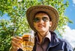 Young Man Is Drinking Beer In The Park Stock Photo