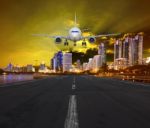 Passenger Air Plane Landing In Urban Airport Against Sunset And Stock Photo