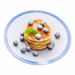 Pile Of Pancakes With Blueberries Sprinkled With Icing Sugar Stock Photo