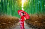 Bamboo Forest. Asian Woman Wearing Japanese Traditional Kimono At Bamboo Forest In Kyoto, Japan Stock Photo