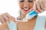 Pretty Young Woman Brushing Her Teeth Stock Photo