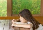 Asian Gir Tired On Desk While Learning Stock Photo