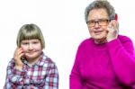 Grandmother And Granddaughter Phoning With Mobile Phone Stock Photo