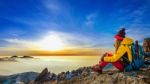 Young Woman Sitting On The Hill Of High Mountains Stock Photo