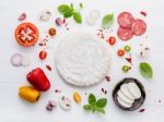 The Ingredients For Homemade Pizza On White Wooden Background Stock Photo