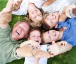 Happy Family Lying As A Circle Stock Photo