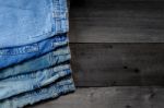 Blue Jean And Jean Lack Texture On The Wooden Floor Stock Photo