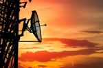 Silhouette Satellite Communication Tower Poles On Sunset Stock Photo