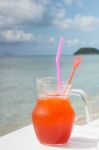 Red Cocktail On White Table Set Over Ocean Stock Photo