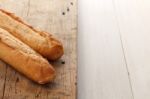 Baguette Bread On Rustic White Wooden Background Stock Photo