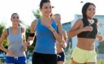 Group Of Women Running In The Park Stock Photo