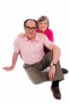 Senior Couple Sitting On Floor Stock Photo