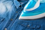 Ironing Blue Jean Shirt Stock Photo