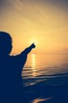 Silhouette Back View Of Woman Relax At Seaside And Pointing To T Stock Photo