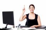 Businesswoman Holding Pen And Raising Her Hand Stock Photo