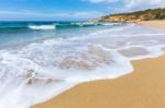 Sandy Beach Sea Waves And Mountain At Coast Stock Photo