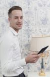 Business Man In A Hotel Room With Tablet Stock Photo