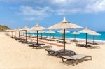 Many Reed Beach Umbrellas In A Row  On Empty Beach At Sea Stock Photo