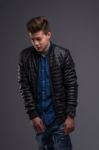 Casual Young Man In Black Leather Jacket And Denim Jeans Stock Photo