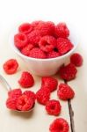 Bunch Of Fresh Raspberry On A Bowl And White Table Stock Photo