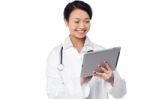 Young Female Doctor Holding A Tablet Stock Photo