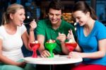 Cheerful Friends Enjoying Tempting Dessert Stock Photo