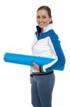 Woman Carrying Blue Yoga Mat Stock Photo