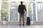 Young Man With Luggage Waiting At Airport Stock Photo