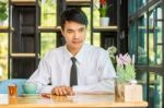 Business Man Using Mobile Phone While Sitting In The Coffee Shop Stock Photo