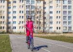 Little Girl In A Safety Helmet Riding A Bicycle Stock Photo