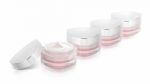 Many Pink Triangle Cosmetic Jar On White Background Stock Photo