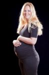 Pregnant Woman Holding Tummy Stock Photo