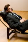 Man Lying On Chaise Longue Stock Photo