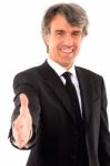 Businessman Holds Out His Hand Stock Photo