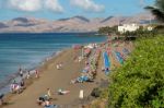 People Relaxing On A Beach In Lanzarote Stock Photo