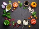 The Ingredients For Homemade Pizza On Dark Stone Background Stock Photo