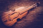 Violin On Grunge Dark Wood Background Stock Photo