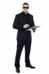 Male Bouncer Holding Clipboard Stock Photo