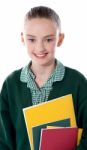 Smiling School Girl Holding Books Stock Photo