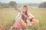 Hippie Girl Playing Guitar On Grass Stock Photo