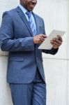 Businessman Using A Tablet Pc, Outdoors Stock Photo