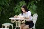 Thai Adult Student University Beautiful Girl Reading Red Book Stock Photo