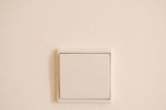 White And Modern Light Switch On Wall Stock Photo