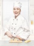 Young Chef Cutting Blue Cheese In Kitchenn Stock Photo