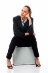 Woman Sitting On Briefcase Stock Photo