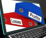 Profit And Looses Files On Laptop Showing Risky Trading Stock Photo