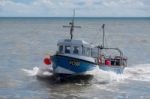 Fishing Boat Racing Home To Lyme Regis Harbour Stock Photo