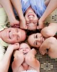 Family Members Lying In A Circle Stock Photo