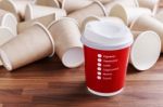 Red Paper Coffee Cup With Paper Cups Background Stock Photo