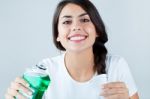 Beautiful Girl Using Mouthwash. Isolated On White Stock Photo